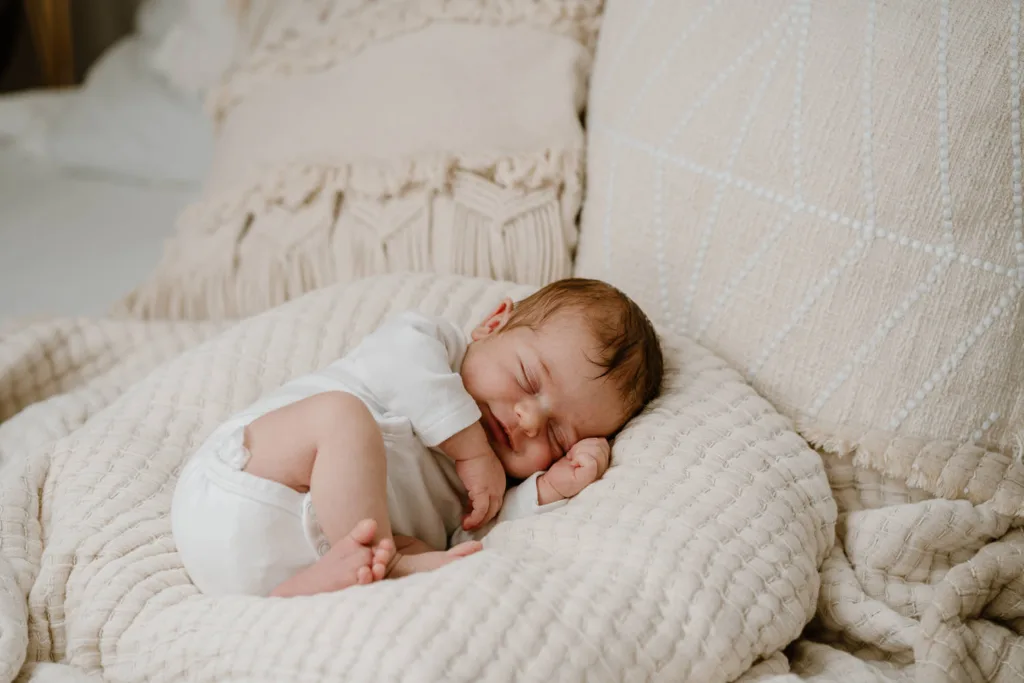 Neugeborenenshooting-Baby liegt in Korb und wird fotografiert