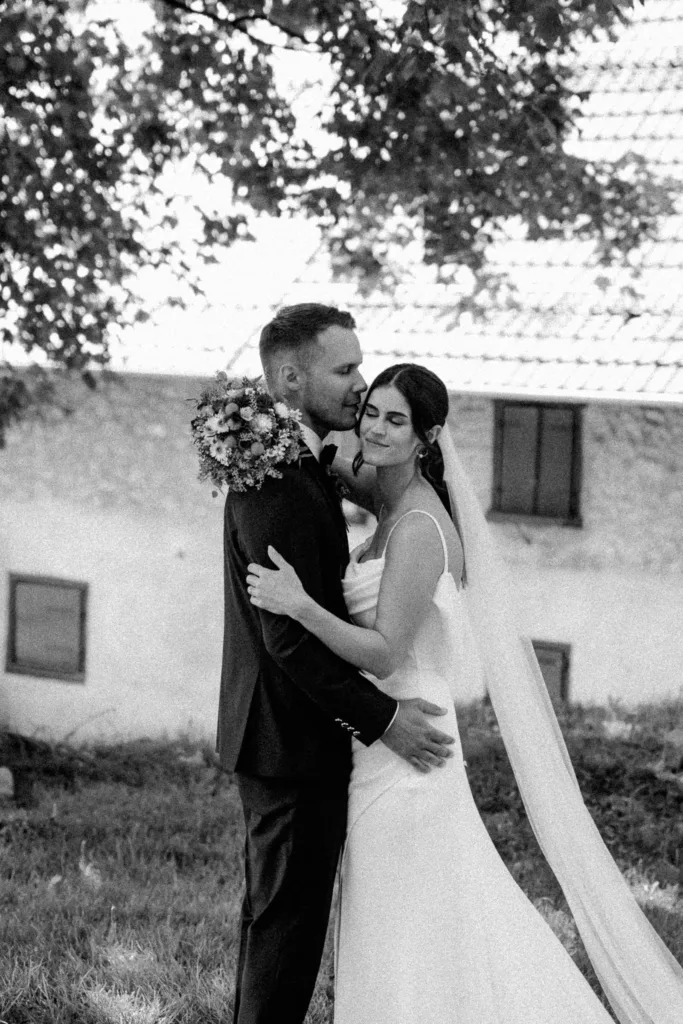 Schwarzweiß Hochzeitsfoto eines innigen Moments des Brautpaares
